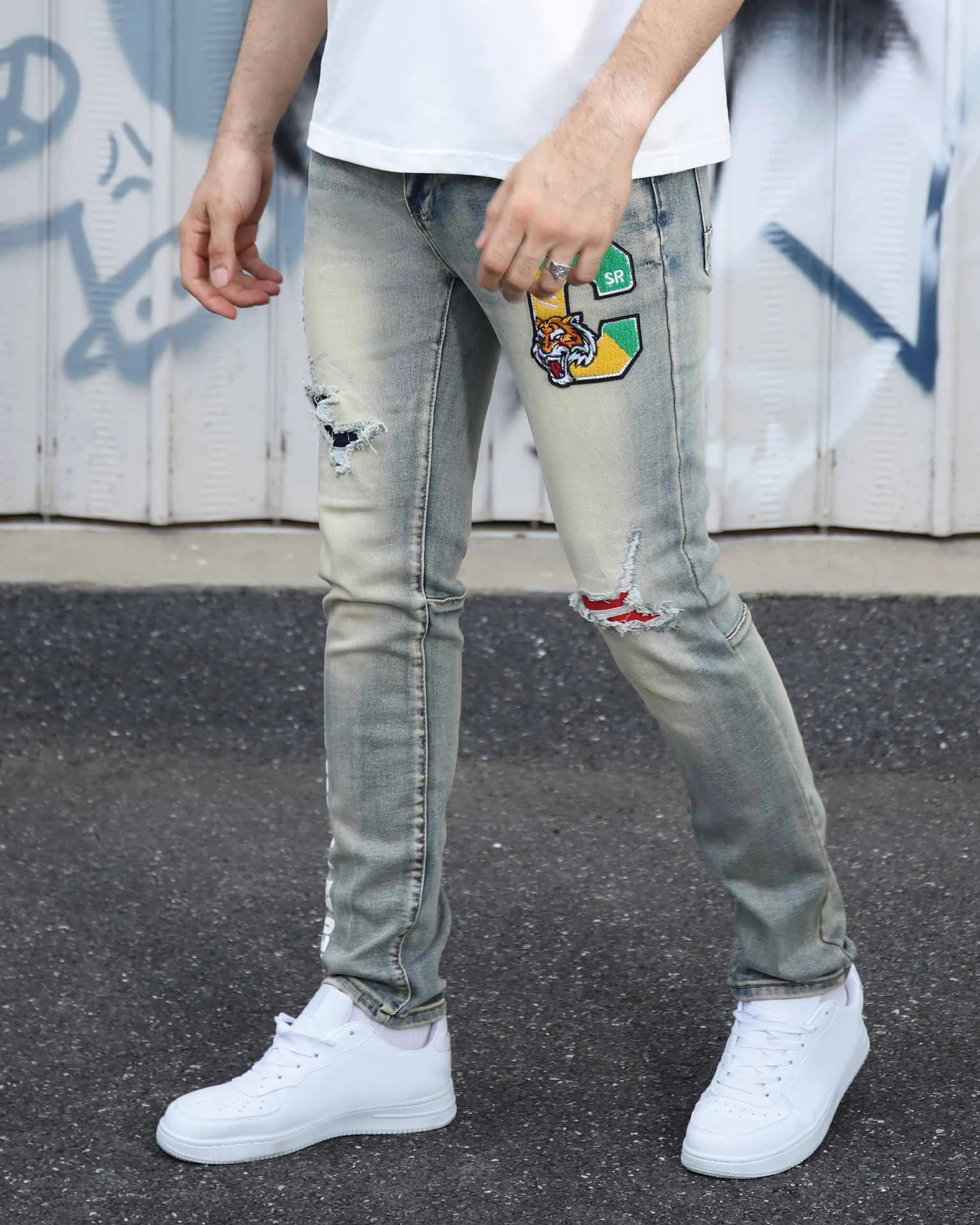 Distressed Light Wash Blue Ripped Jeans with Lion Motif Embroider