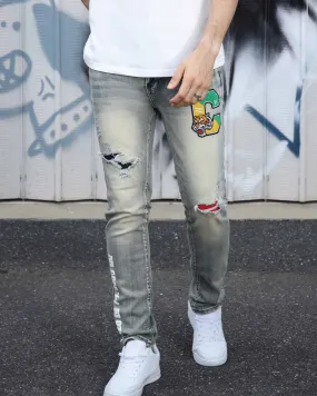 Distressed Light Wash Blue Ripped Jeans with Lion Motif Embroider