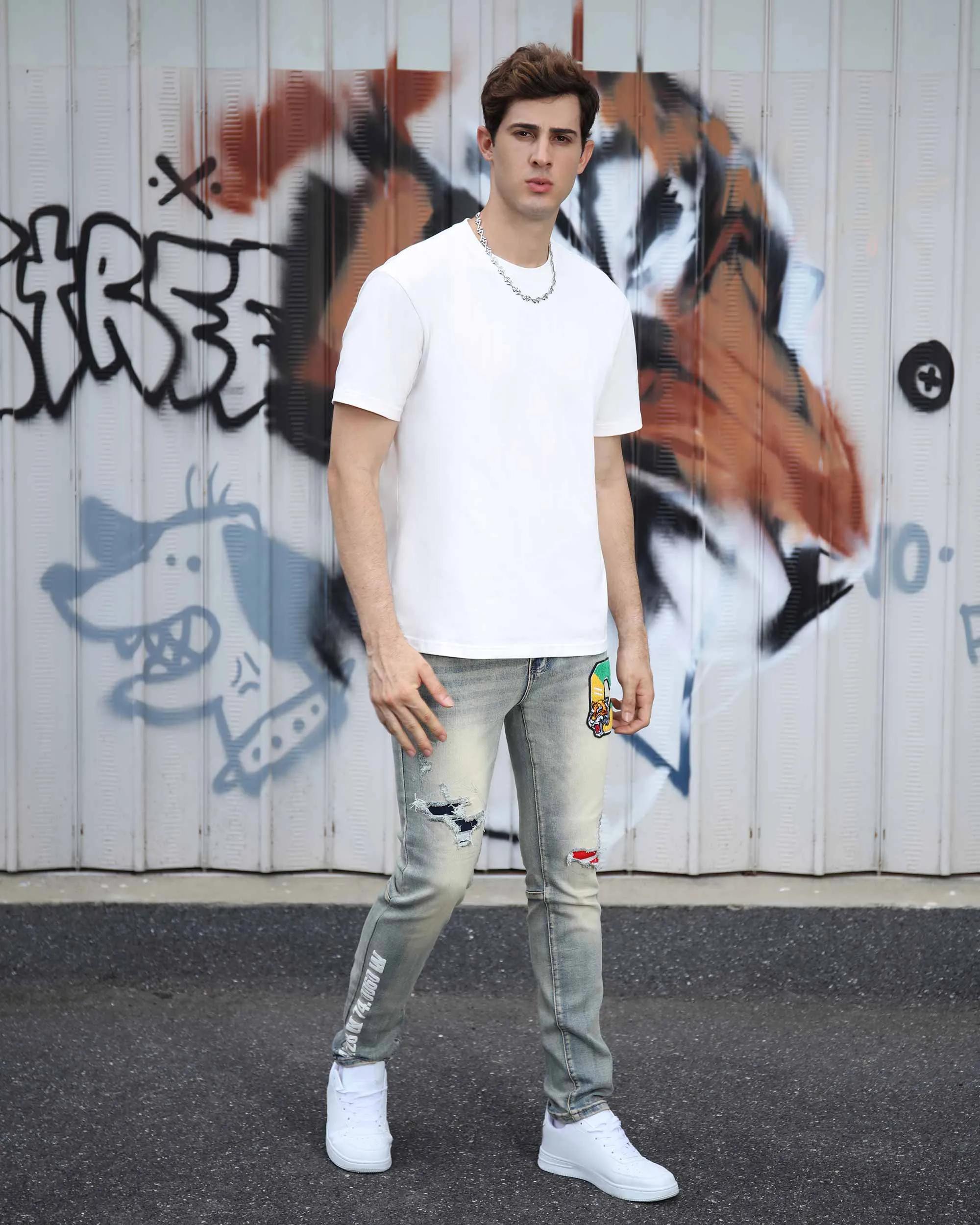 Distressed Light Wash Blue Ripped Jeans with Lion Motif Embroider