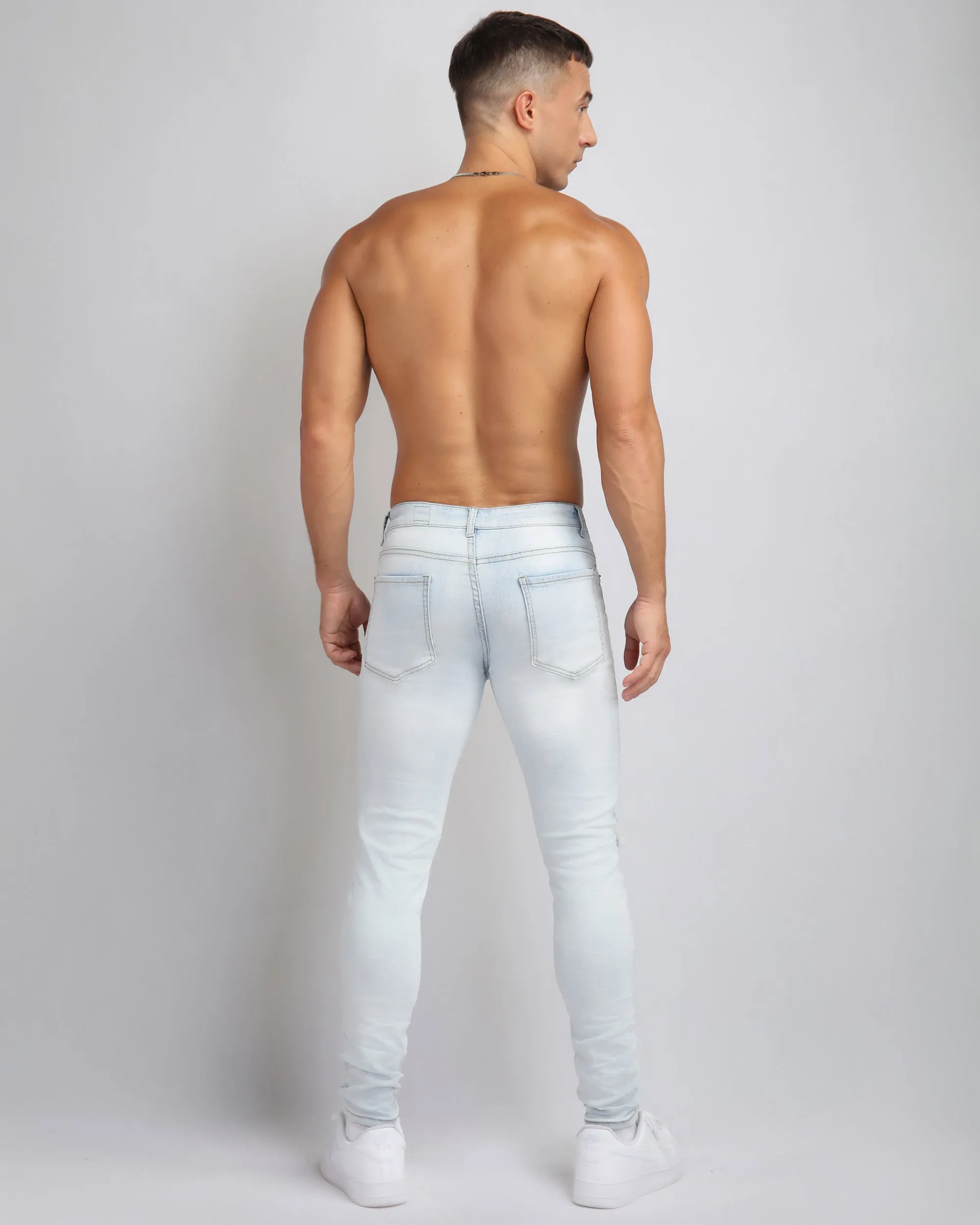Light Wash Ripped Blue Jeans with Camouflage Patch